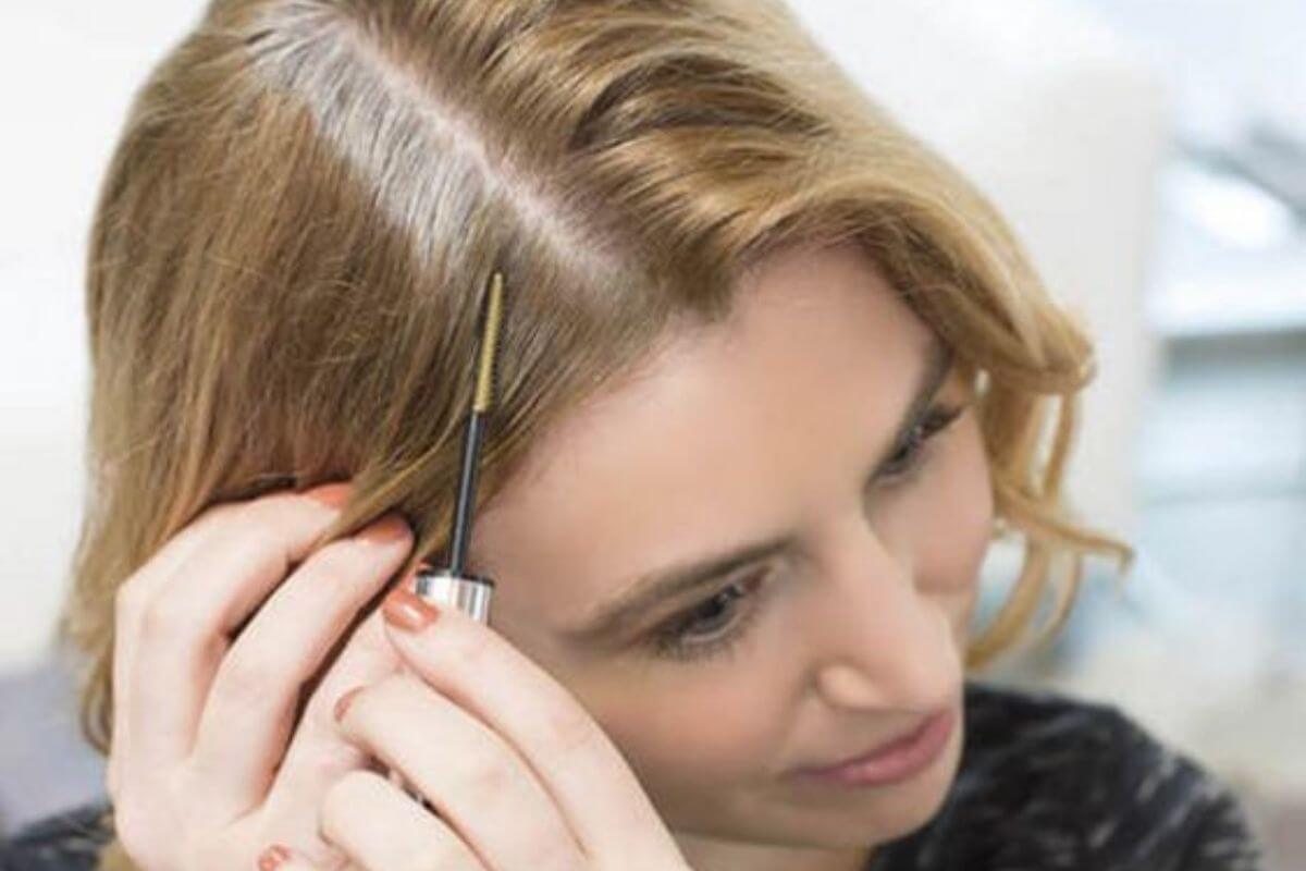 woman showing the crown of her head to show her hair regrowth