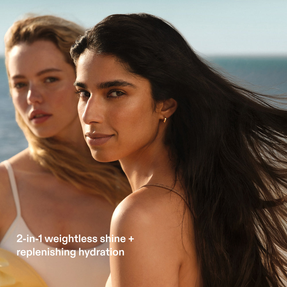 Two women with healthy shiny hair at the beach showing Olaplex No.7 Shine Serum Oil Mist weightless shine and replenishing hydration