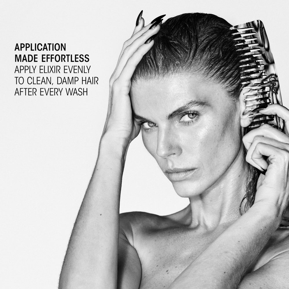 Model combing Oribe Hair Alchemy Bond Building Elixir evenly through clean damp hair after washing