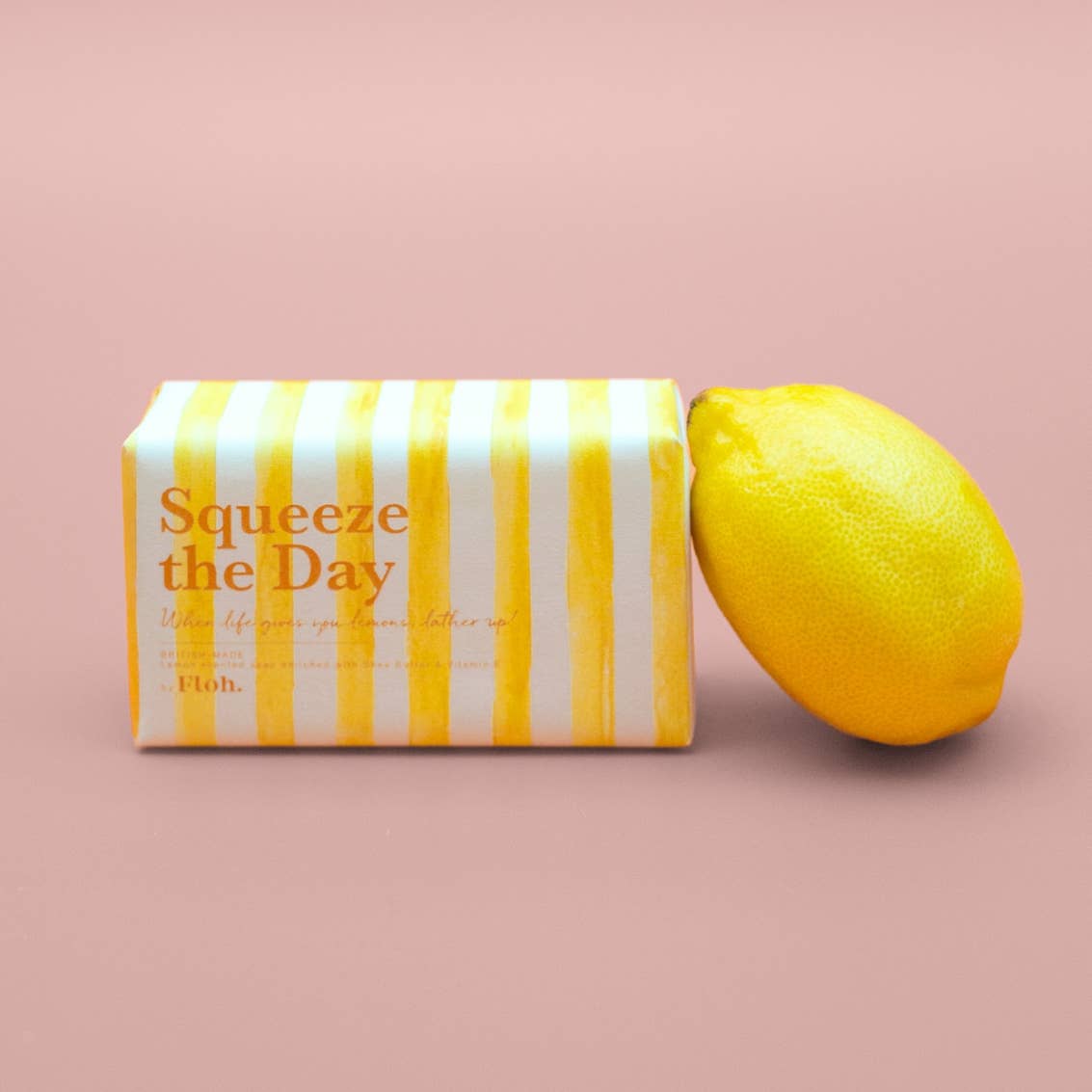 Toasted Crumpet Squeeze the Day 190g soap bar beside a whole lemon on a soft pink background
