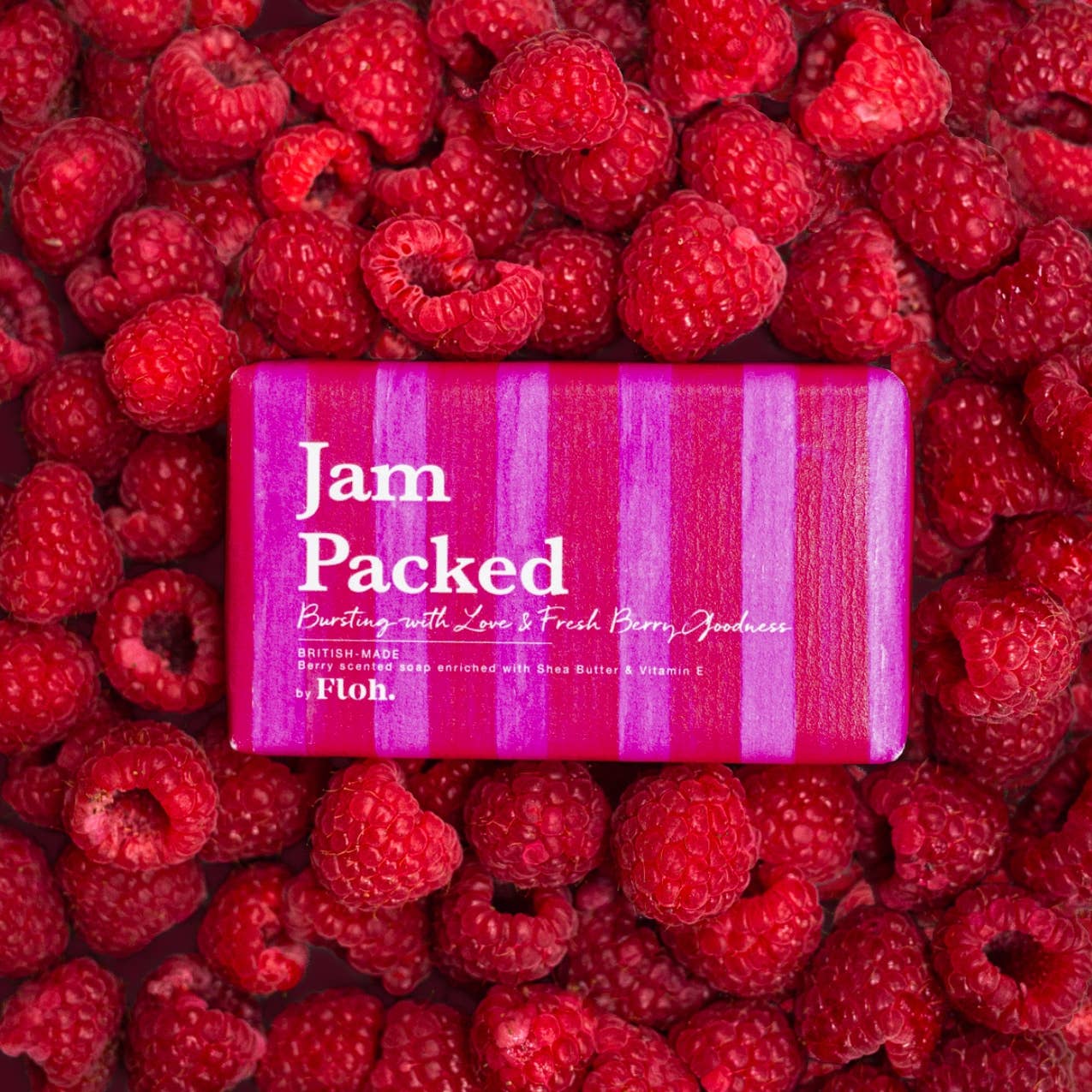 Toasted Crumpet Jam Packed 190g soap bar in pink striped wrap on a bed of raspberries