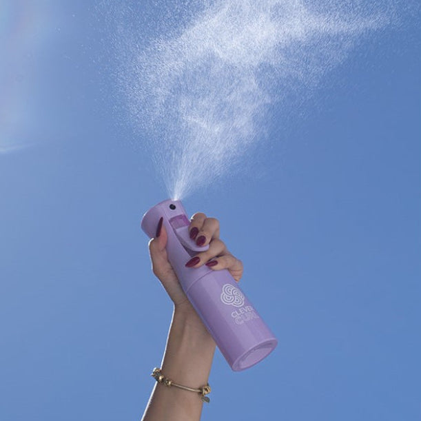 Clever Curl Water Spray Bottle spraying fine mist on curly hair