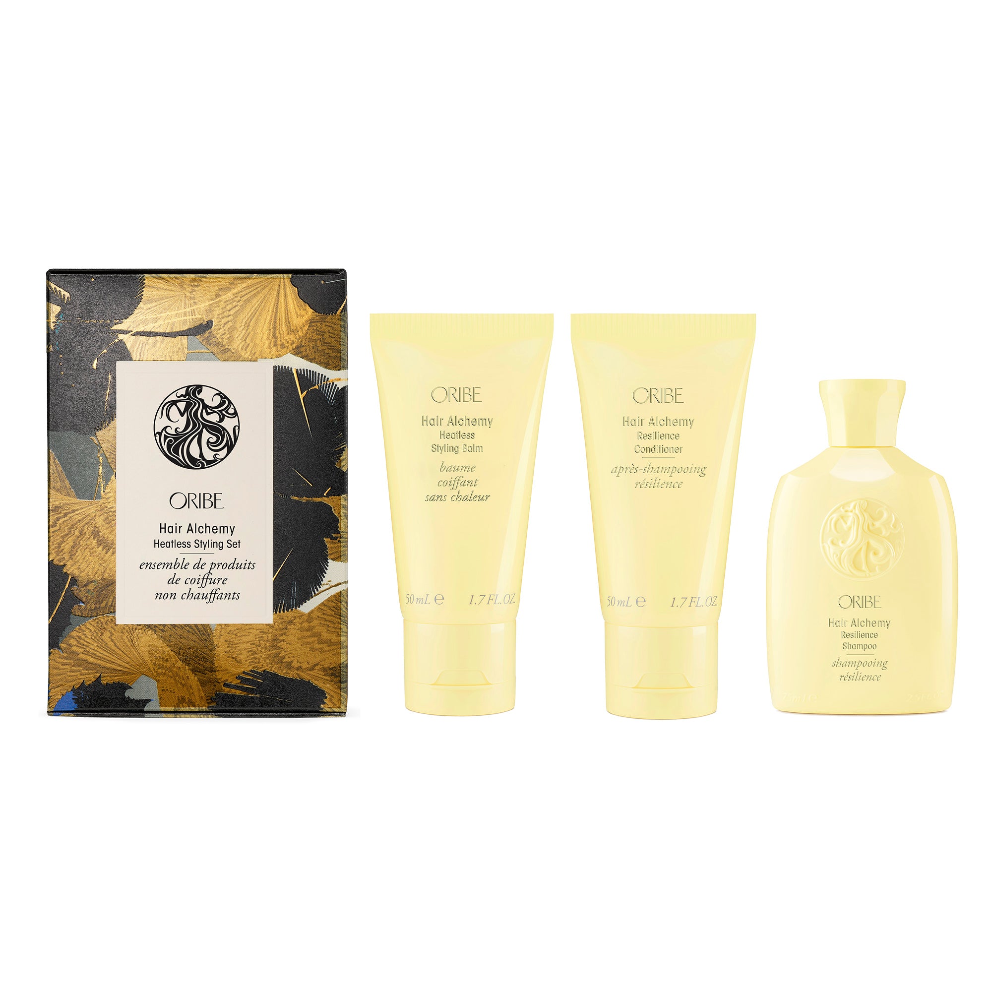 Set of Oribe Hair Alchemy travel size products including a box, shampoo, conditioner, and serum on a white background for the Christmas holiday pack