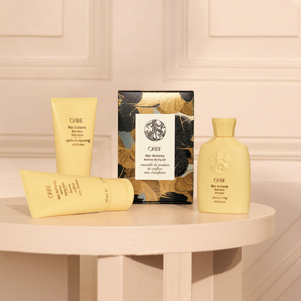 Oribe hair alchemy heatless style set holiday pack on a table with a neutral background