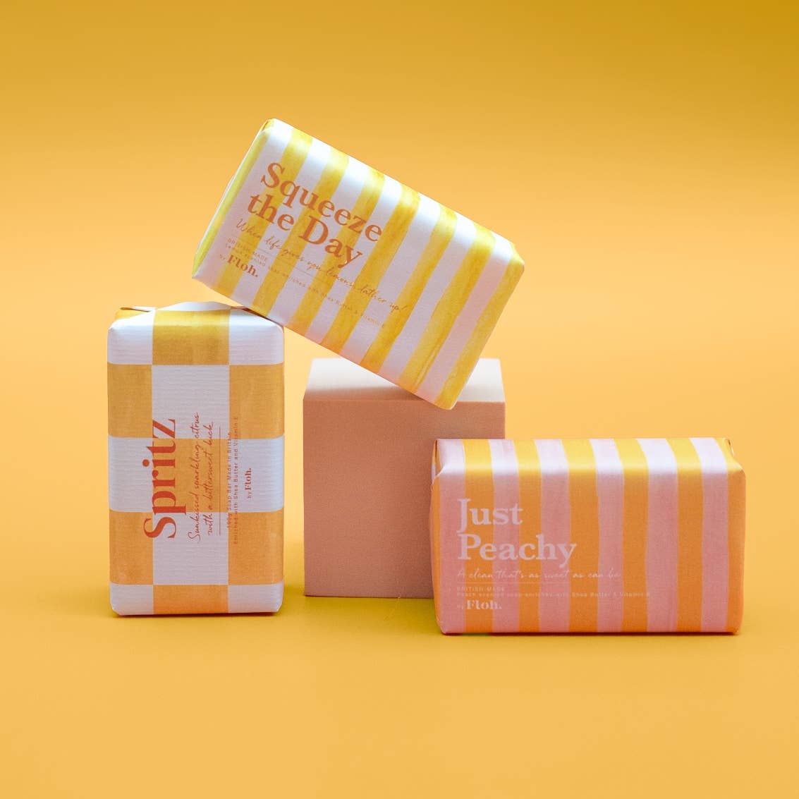 Toasted Crumpet Squeeze the Day and Just Peachy soap bars stacked on a yellow background