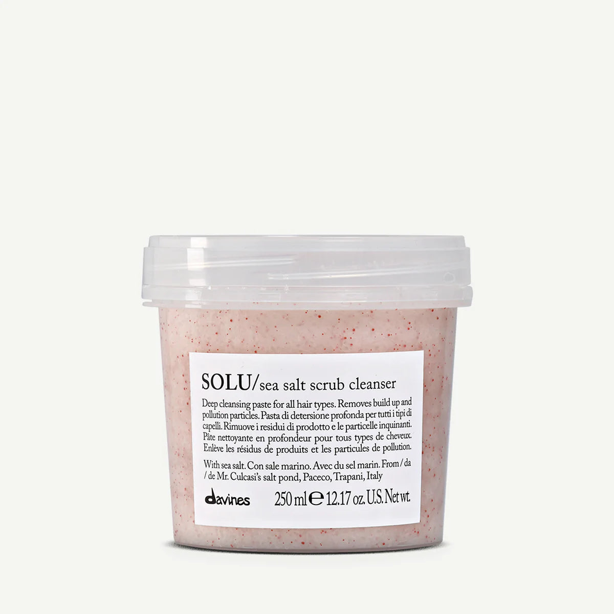Sea salt scrub cleanser container with a white label on a light gray background