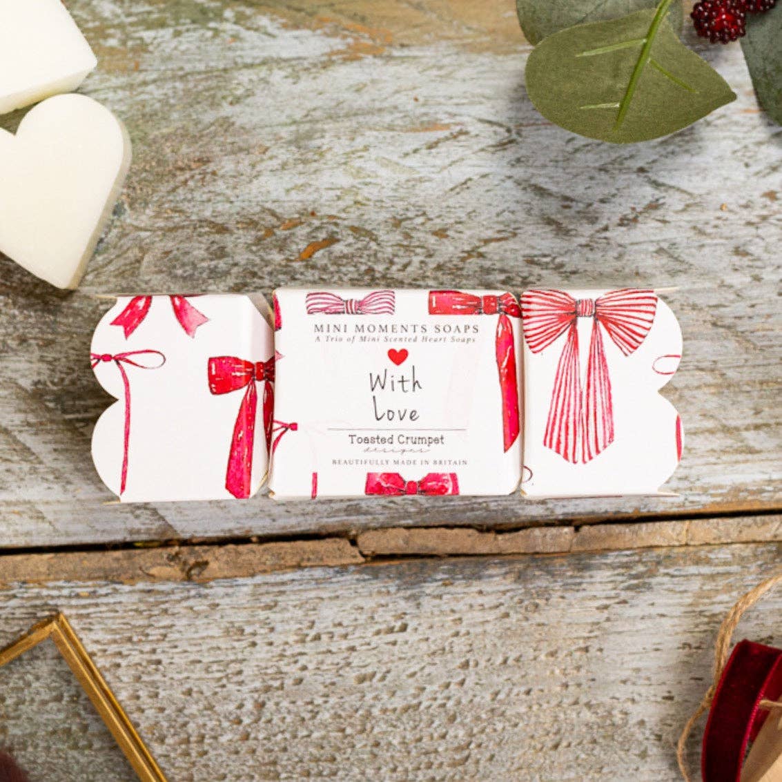 Toasted Crumpet Crimson Velvet cracker shaped gift box of three heart shaped mini soaps on a wooden table