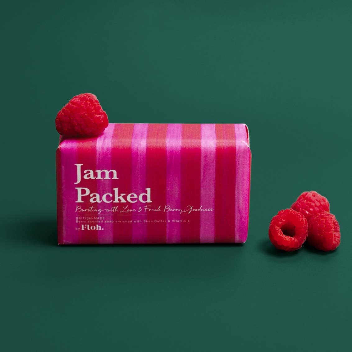 Toasted Crumpet Jam Packed 190g soap bar with fresh raspberries on a deep green background