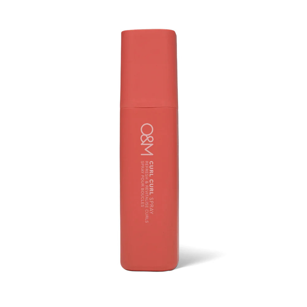 Red cylindrical bottle with 'O&M Curl Curl Spray' branding on a white background
