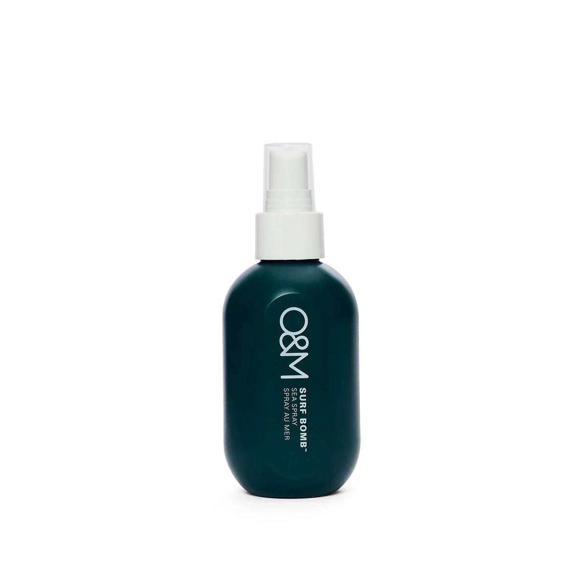 A dark teal spray bottle with a white pump dispenser, featuring the vertical white text 'O&M' and 'BREEZES BREEZE SPRAY' on the front, set against a plain white background.