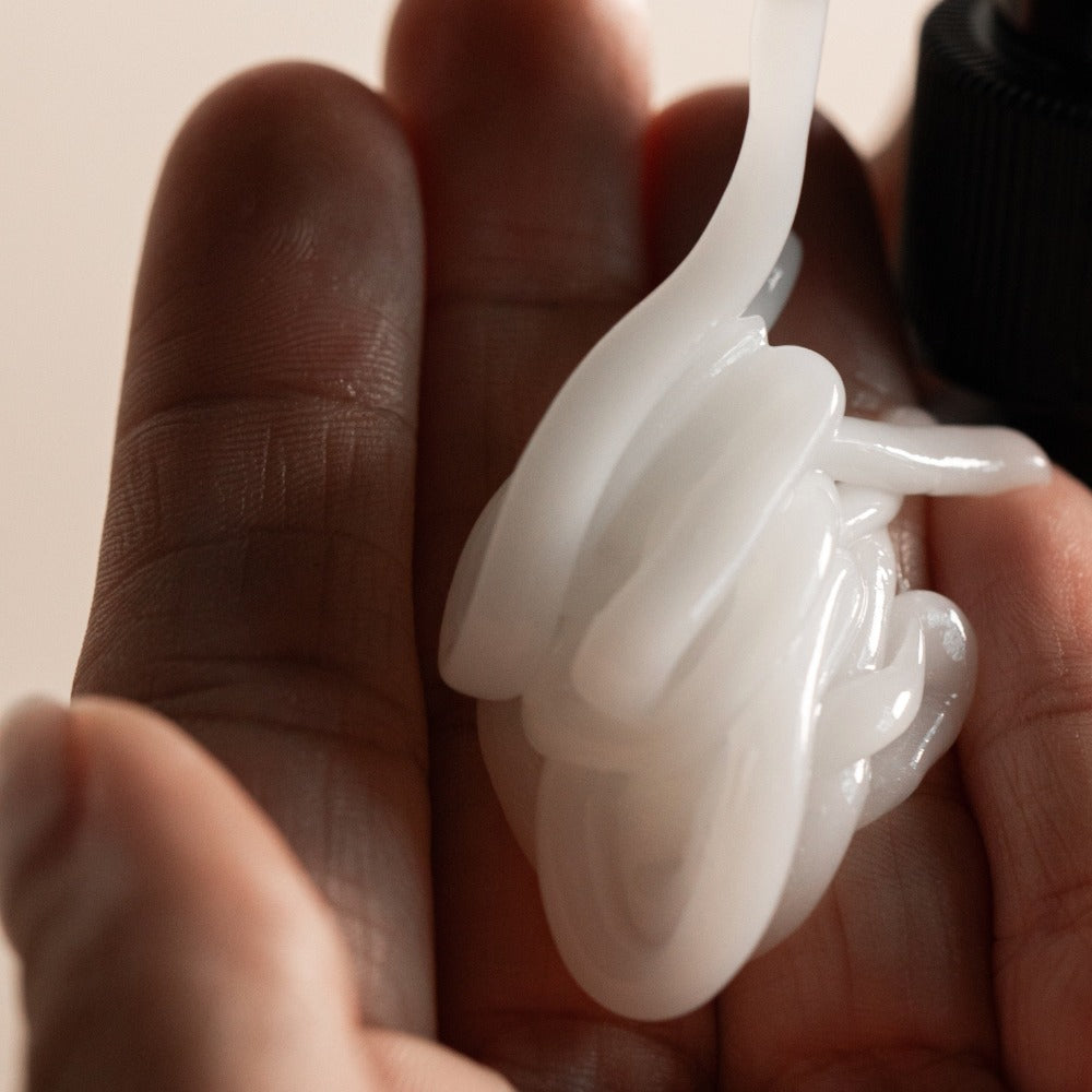 Oway Curly Hair Combing Cream creamy texture in hand