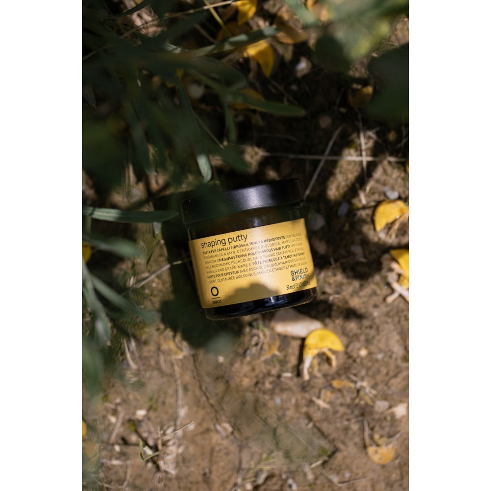Oway Shaping Putty 50ml jar amongst greenery