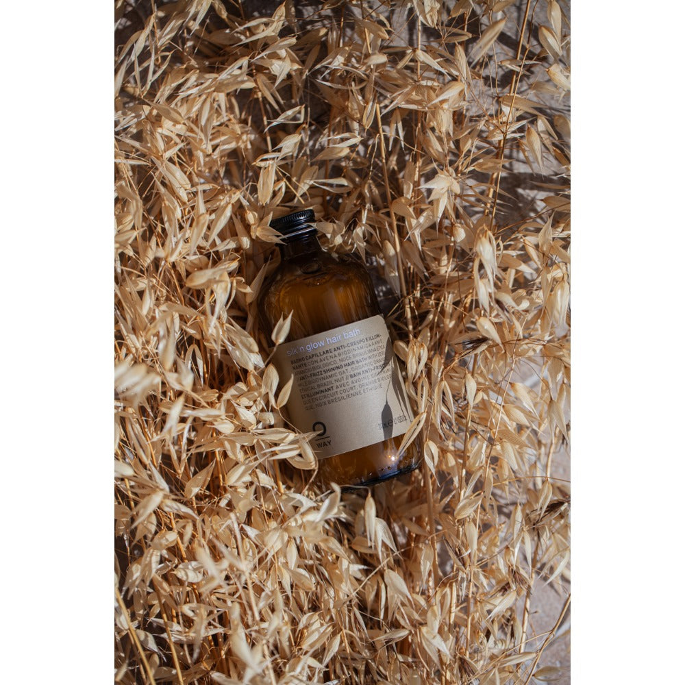 Oway Silk'n Glow Hair Bath bottle amongst greenery