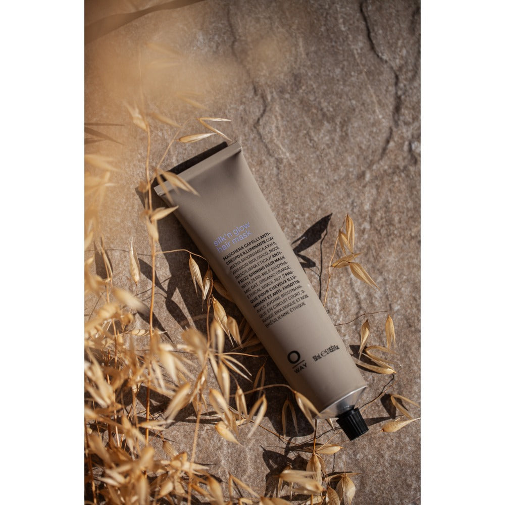 Oway Silk'n Glow Hair Mask 150ml tube amongst dried grasses