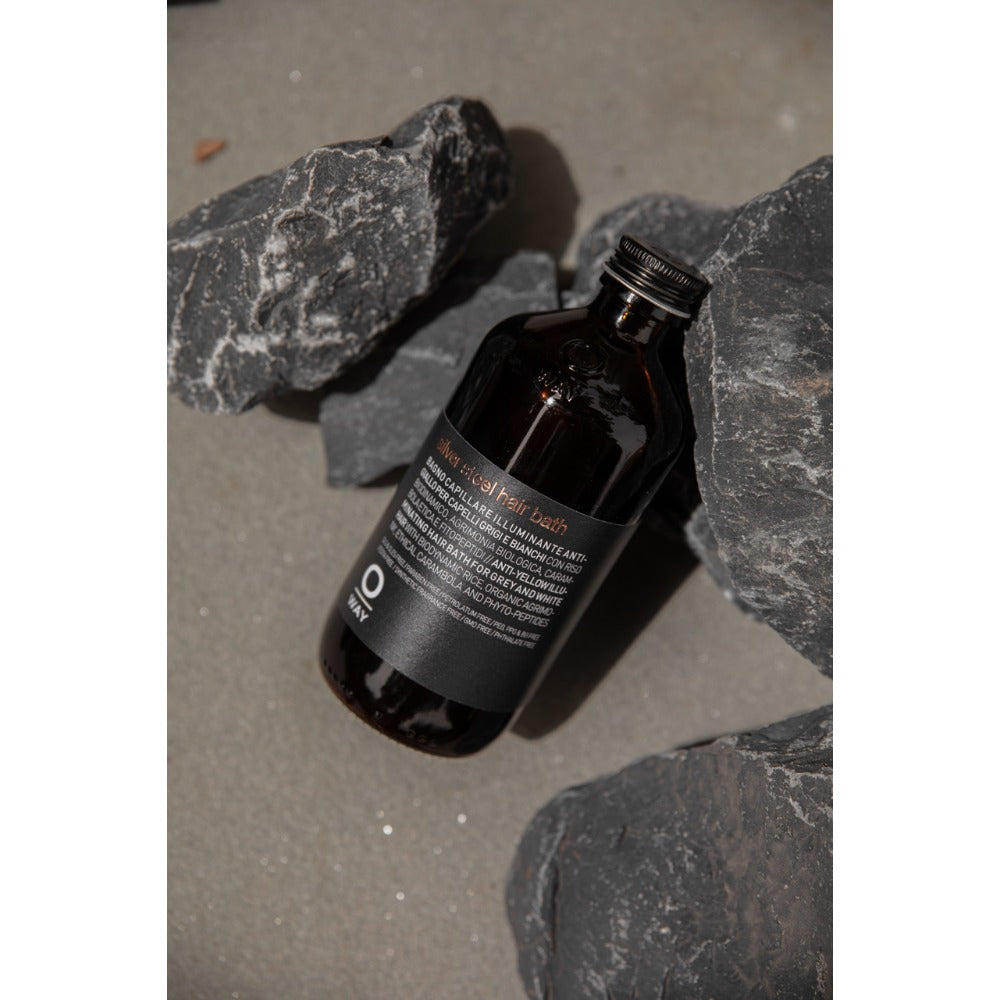 Oway Silver Steel Hair Bath bottle on dark slate