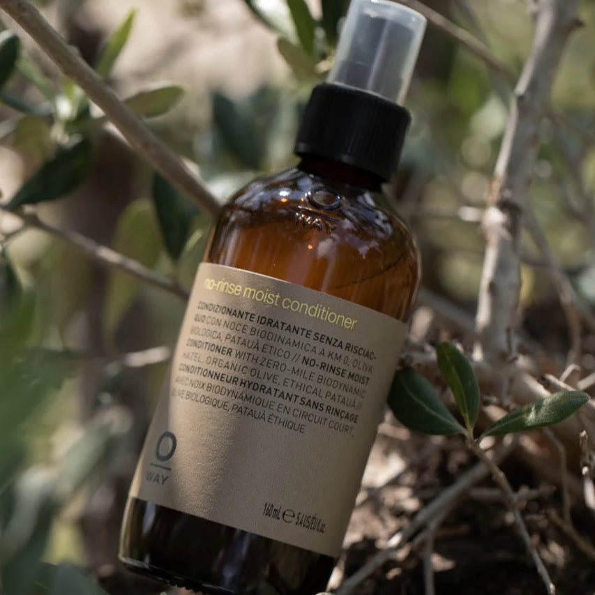 Bottle of Oway No-rinse conditioner on a natural background
