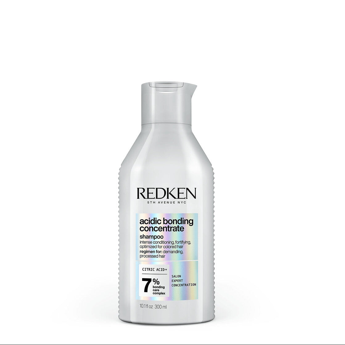 Redken bottle of acidic bonding concentrate on a white background