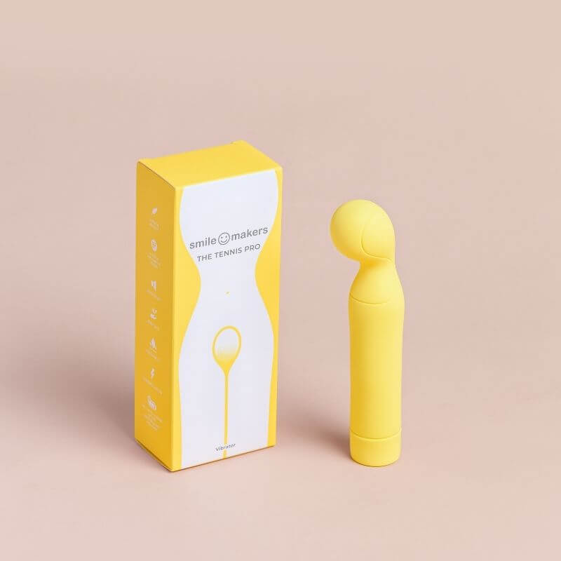 The Tennis Pro Vibrator brought to you by Smile Makers. Picture shows the vibrator standing next to the box.