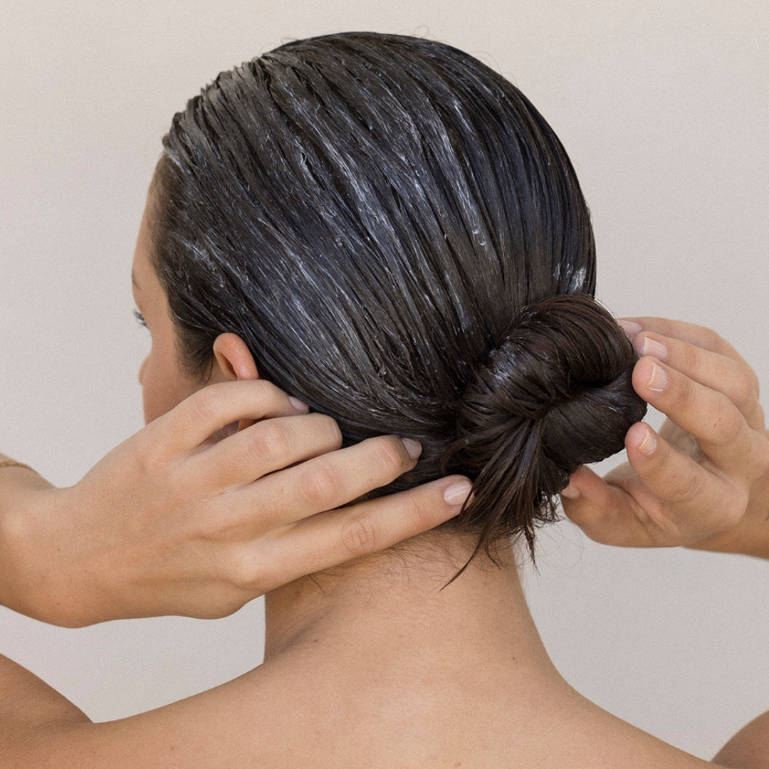 Model applying CZE Silk Treatment Balm repairing hair mask through hair