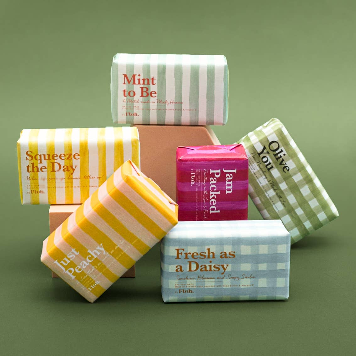 Toasted Crumpet soap bar range including Mint to Be, Squeeze the Day, Jam Packed, Olive You and Fresh as a Daisy on a green background