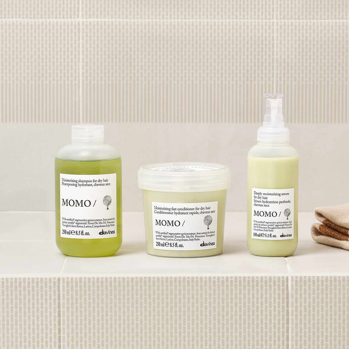 Davines MOMO Serum lifestyle shot, hydrating leave-in serum in use on dry hair