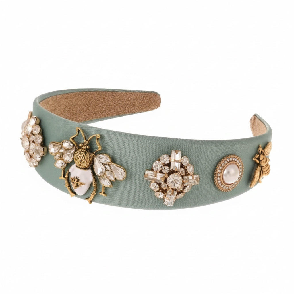 Decorative headband with embellishments on a white background