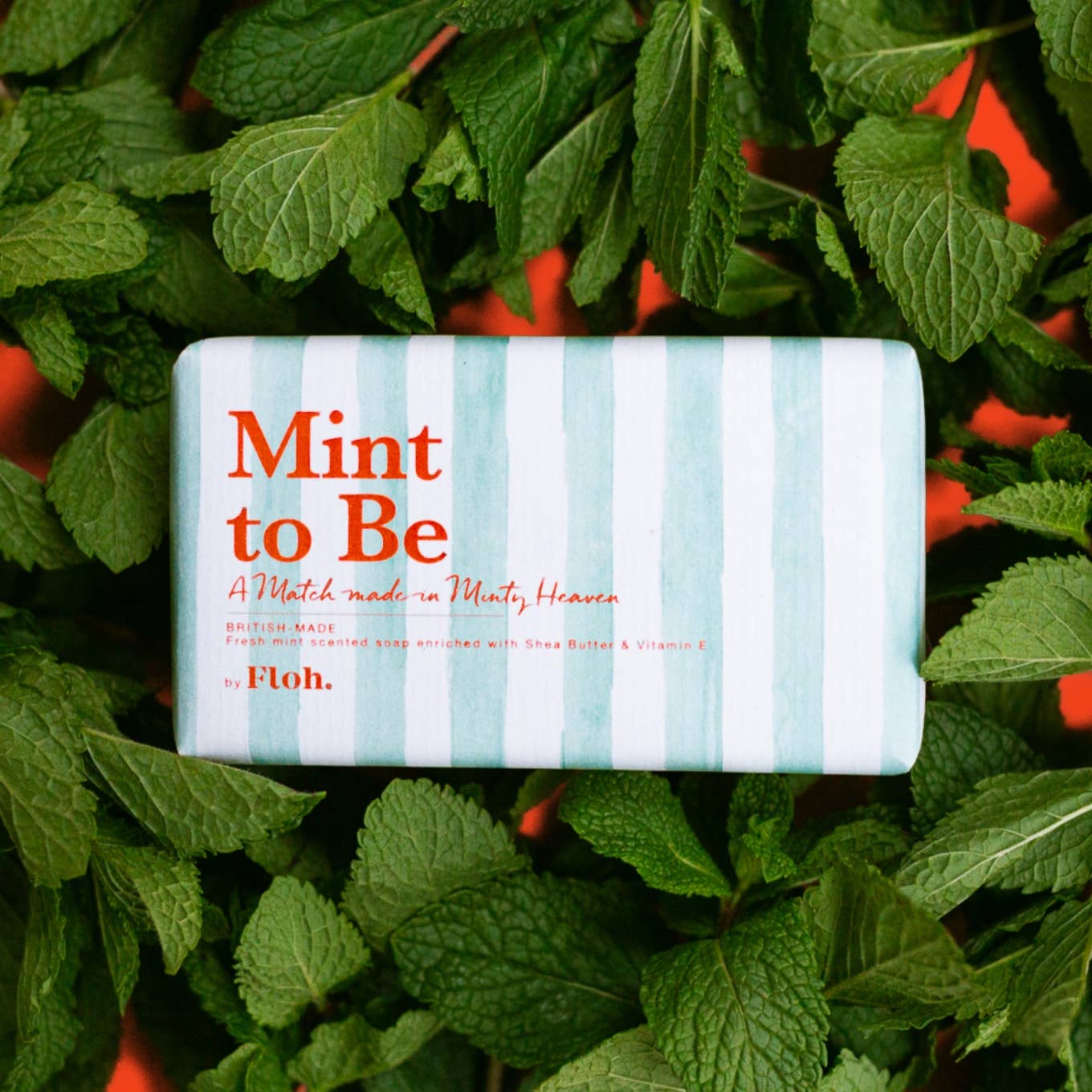 Toasted Crumpet Mint to Be 190g soap bar in striped mint wrap resting on fresh mint leaves