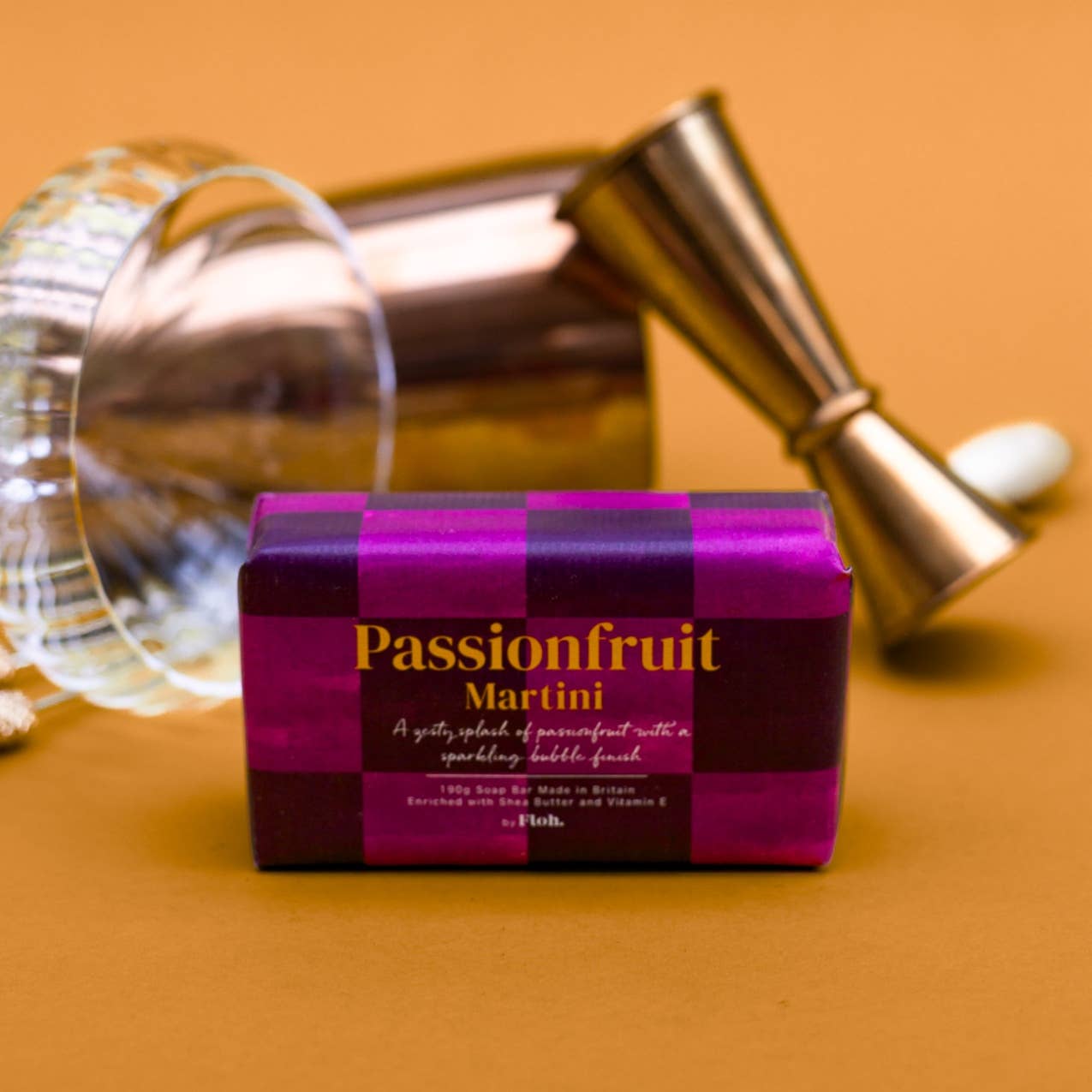 Toasted Crumpet Passionfruit Martini 190g soap bar with a cocktail jigger and glass on an amber background