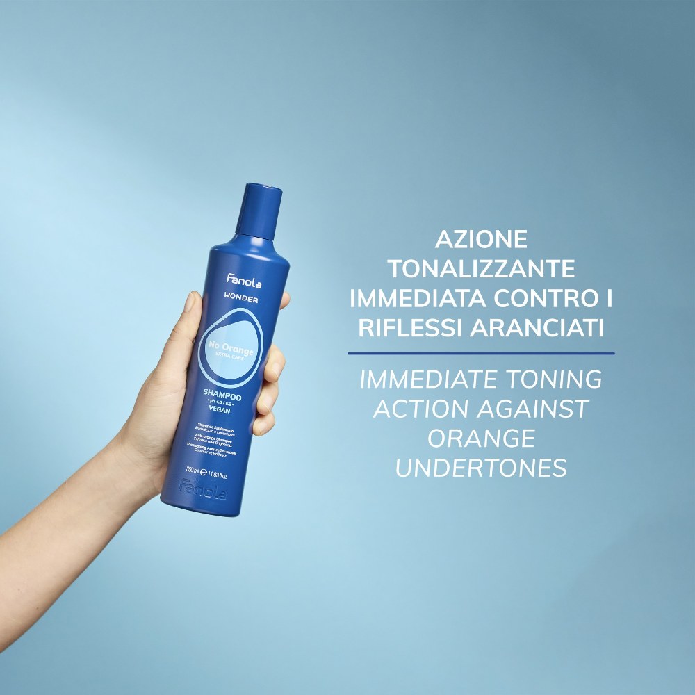 Fanola Wonder No Orange Shampoo 350ml held in hand, blue toning shampoo for brassy light brown hair
