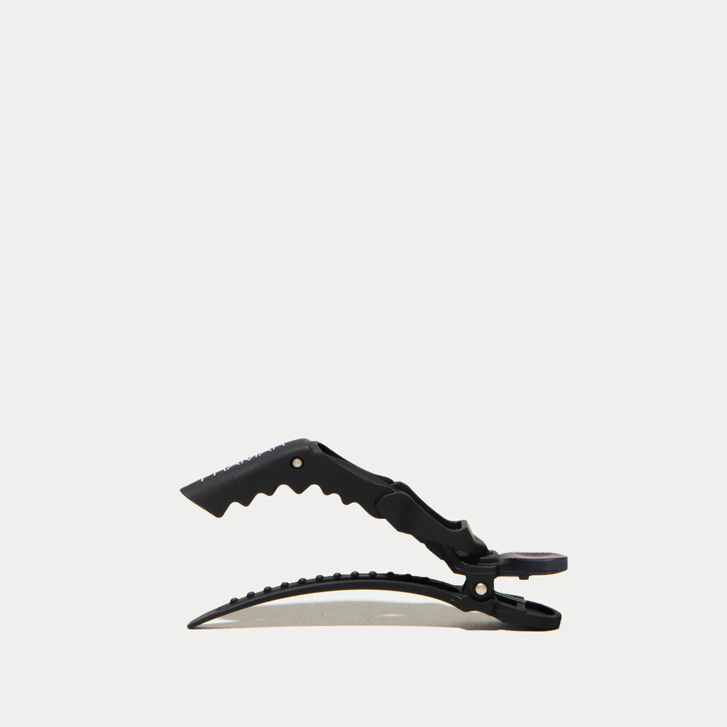 Black crocodile clip on a white background