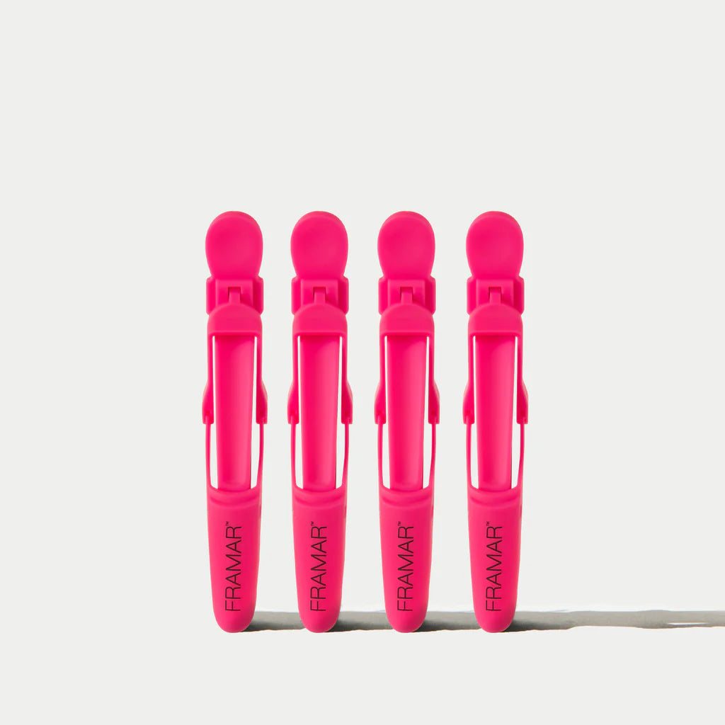 Four pink hair clips with 'Framar' branding on a white background
