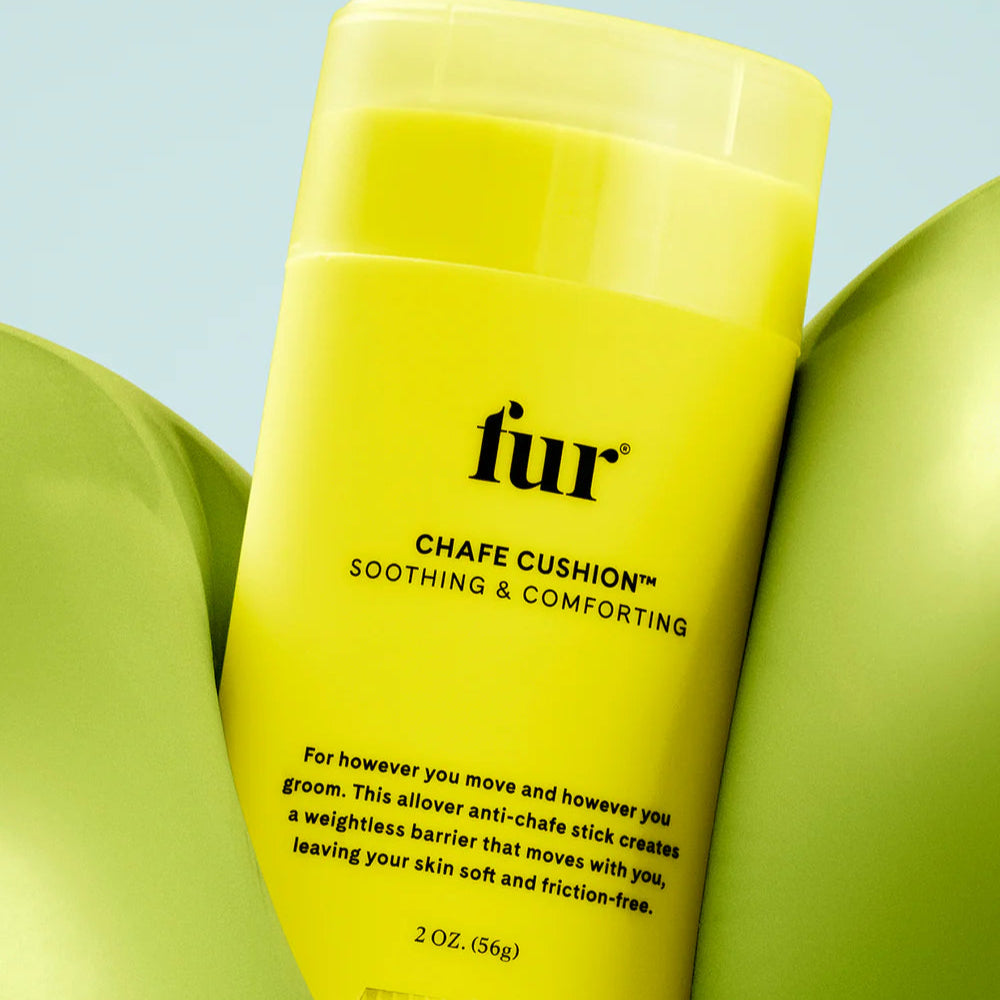 Yellow bottle of fur chafe cushion with green leaves on a light blue background