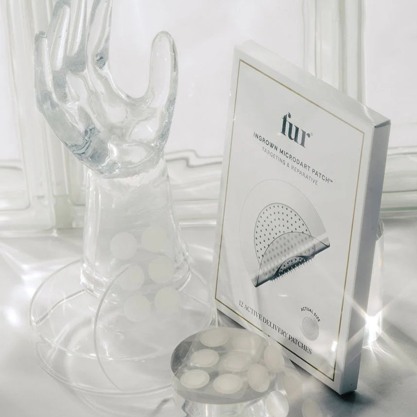 Clear glass object with a box labeled 'fur' on a white surface