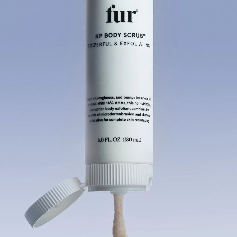 Fur KP Body Scrub bottle on a clear stand with a light blue background