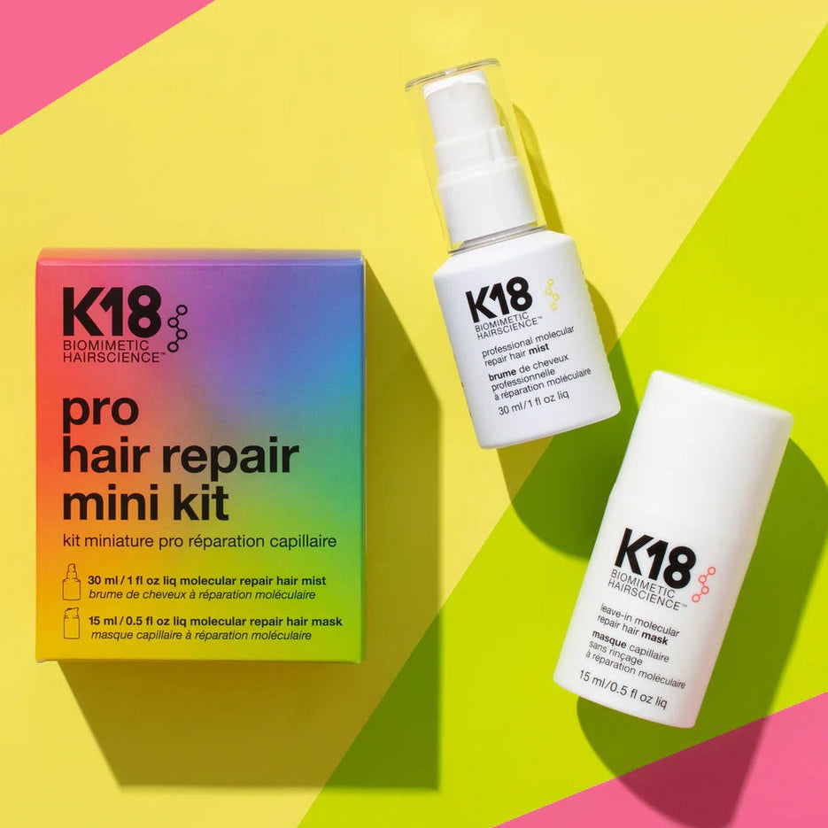K18 pro hair repair mini kit with bottles on a colorful geometric background