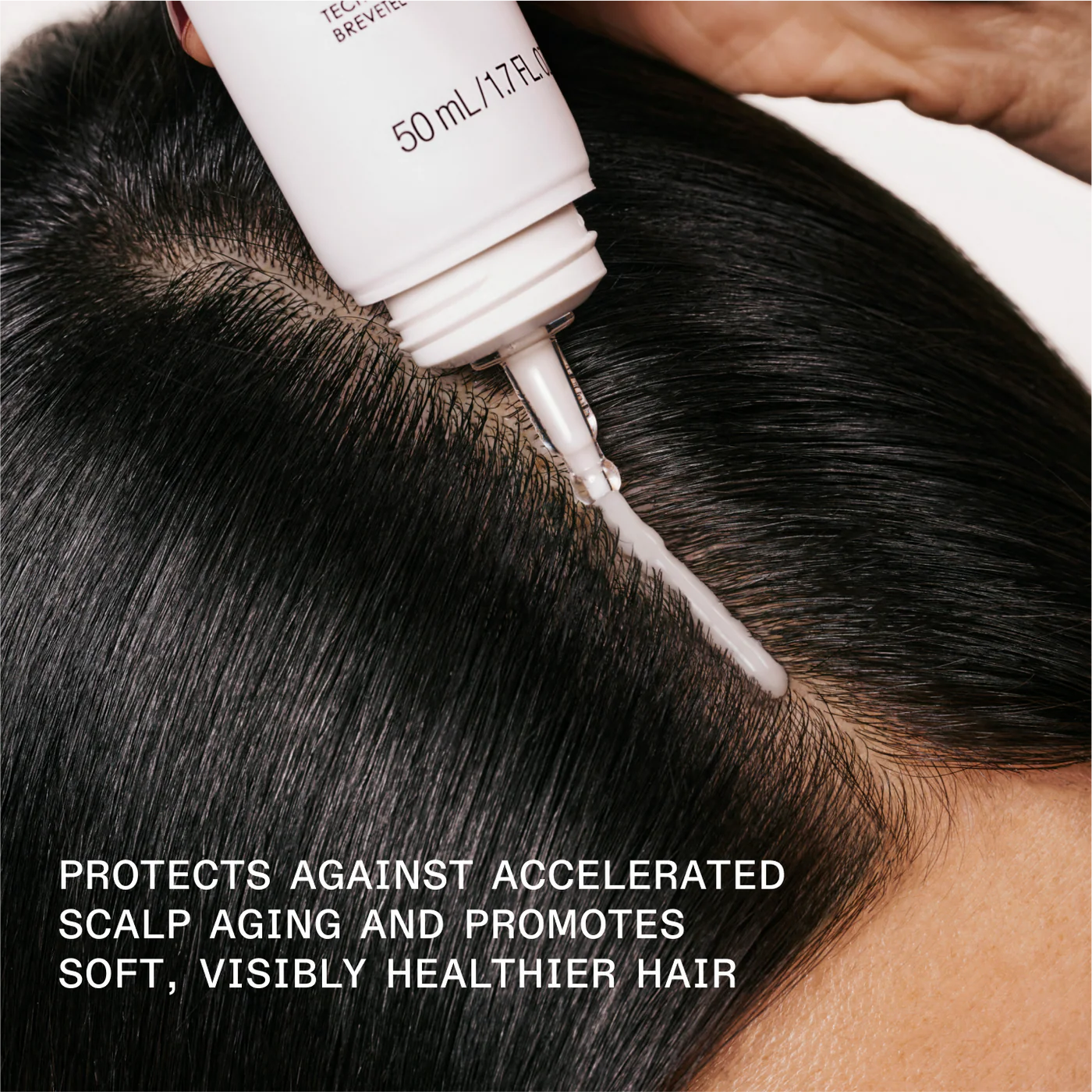 Person applying a hair care product to their scalp with text about hair health benefits.