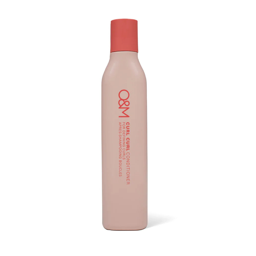 Bottle of O&M Curl Curl Conditioner with a red cap on a white background