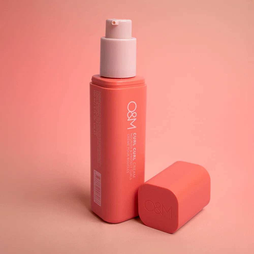 Original Mineral O&M Curl Curl Cream red bottle with white cap on a pink background
