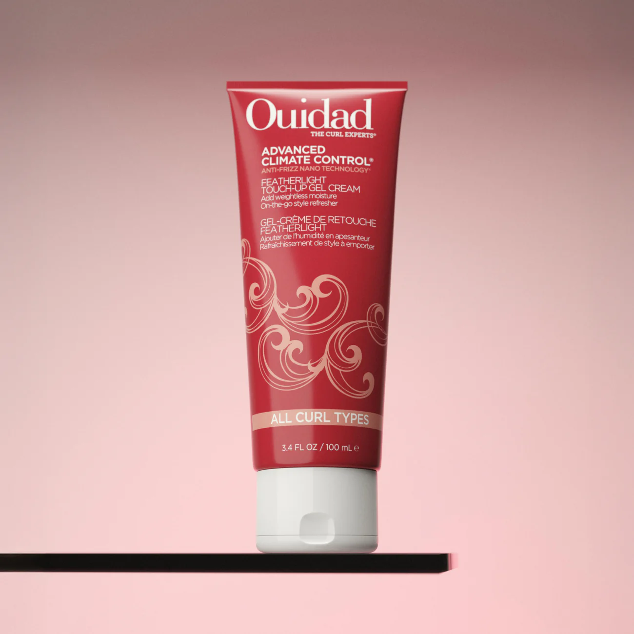 Ouidad Advanced Climate Control Touch-Up Gel Cream tube on a pink background