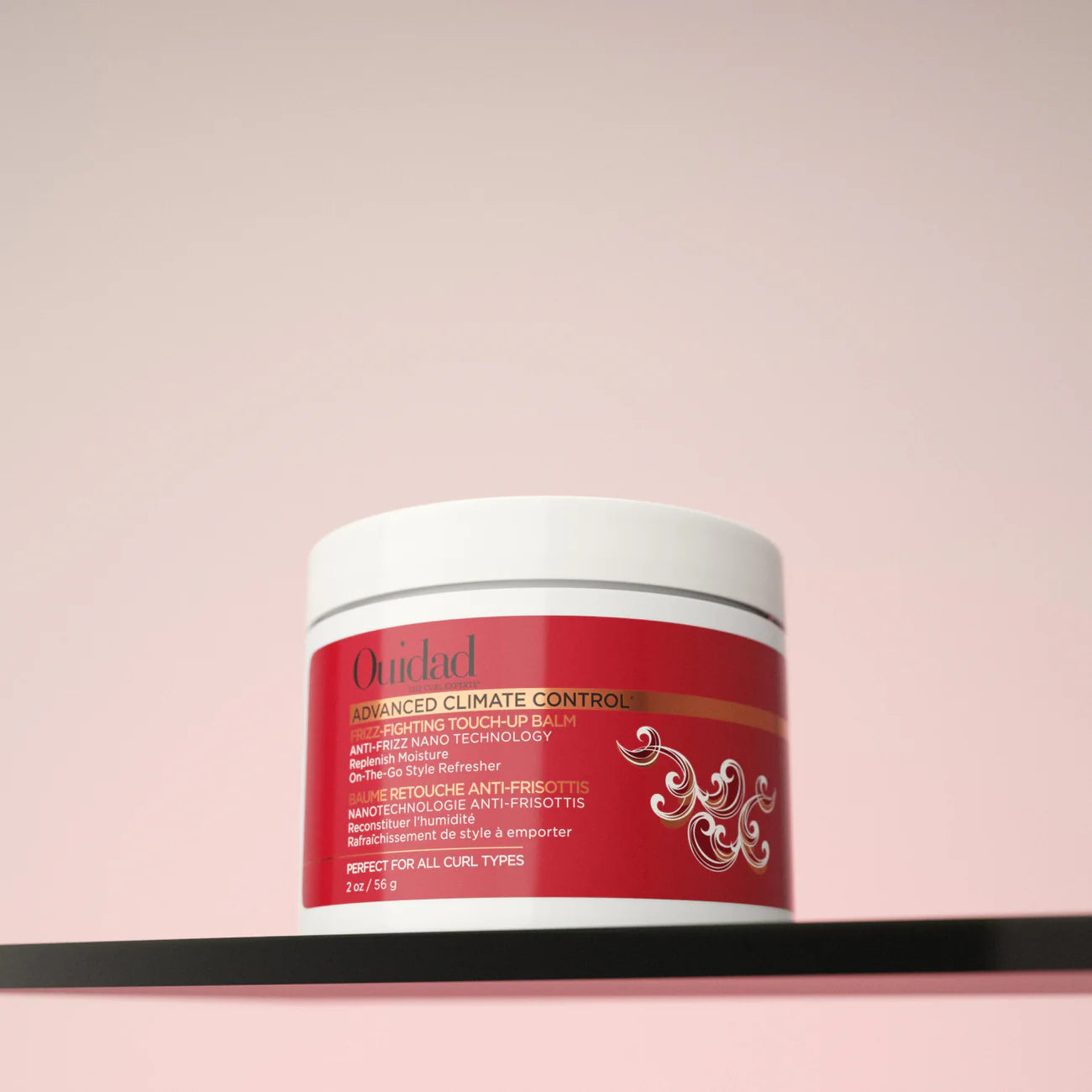 Ouidad Advanced Climate Control balm jar on a pink background