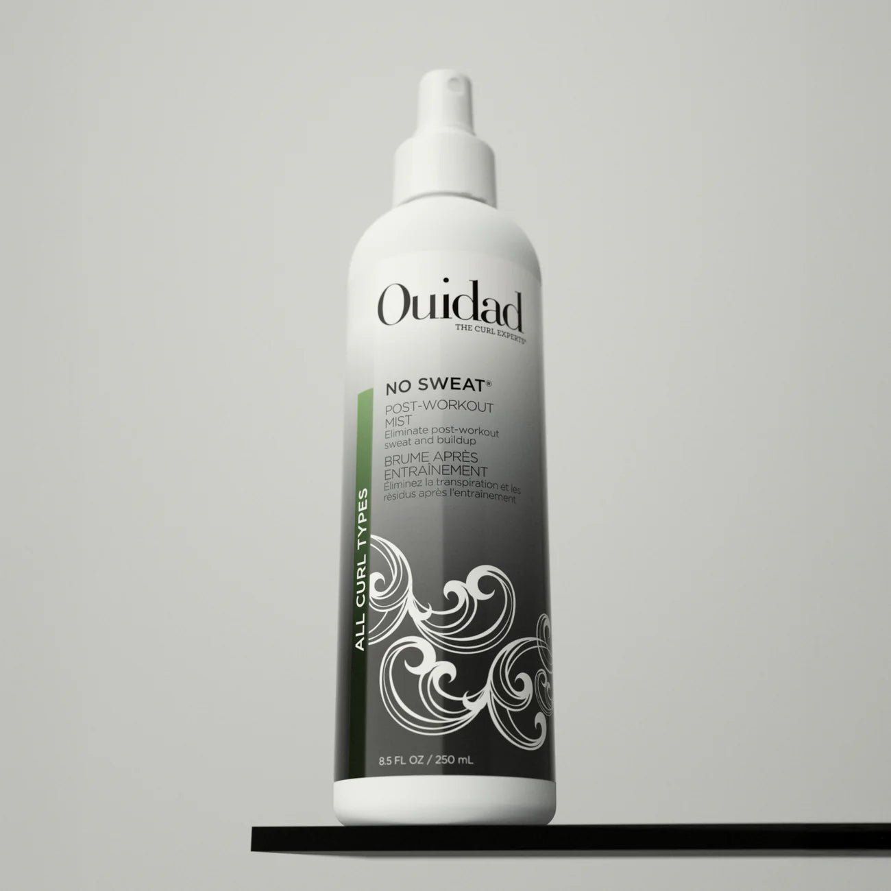 Ouidad No Sweat Post-Workout Mist on a gray background