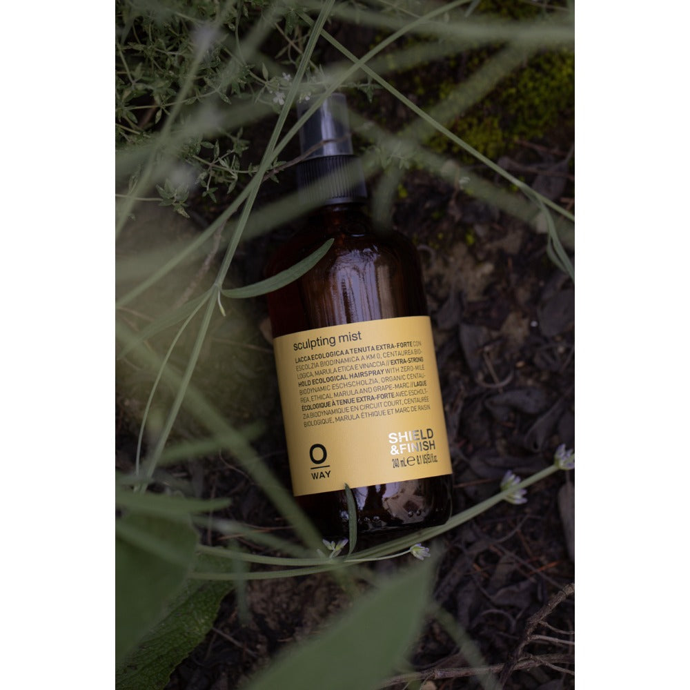Oway Sculpting Mist bottle amongst greenery