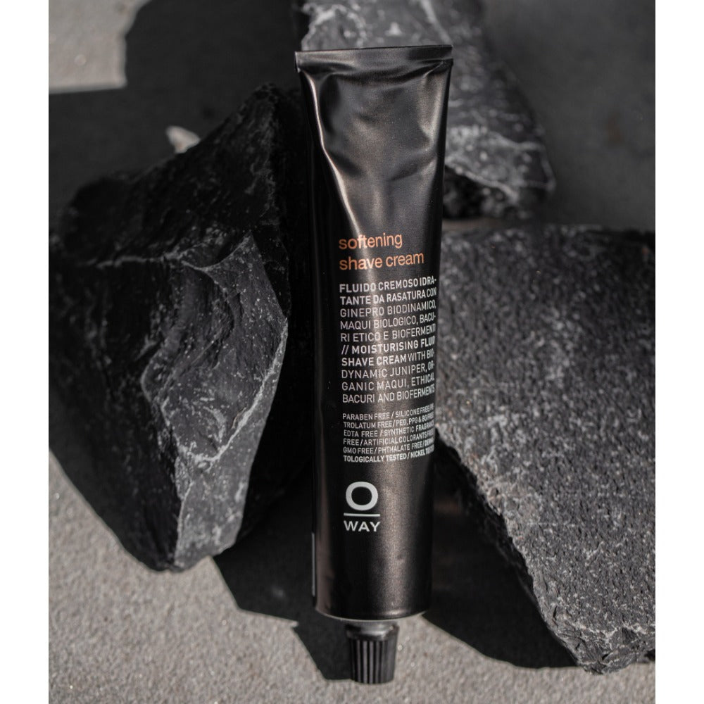 Oway Softening Shave Cream tube on dark slate