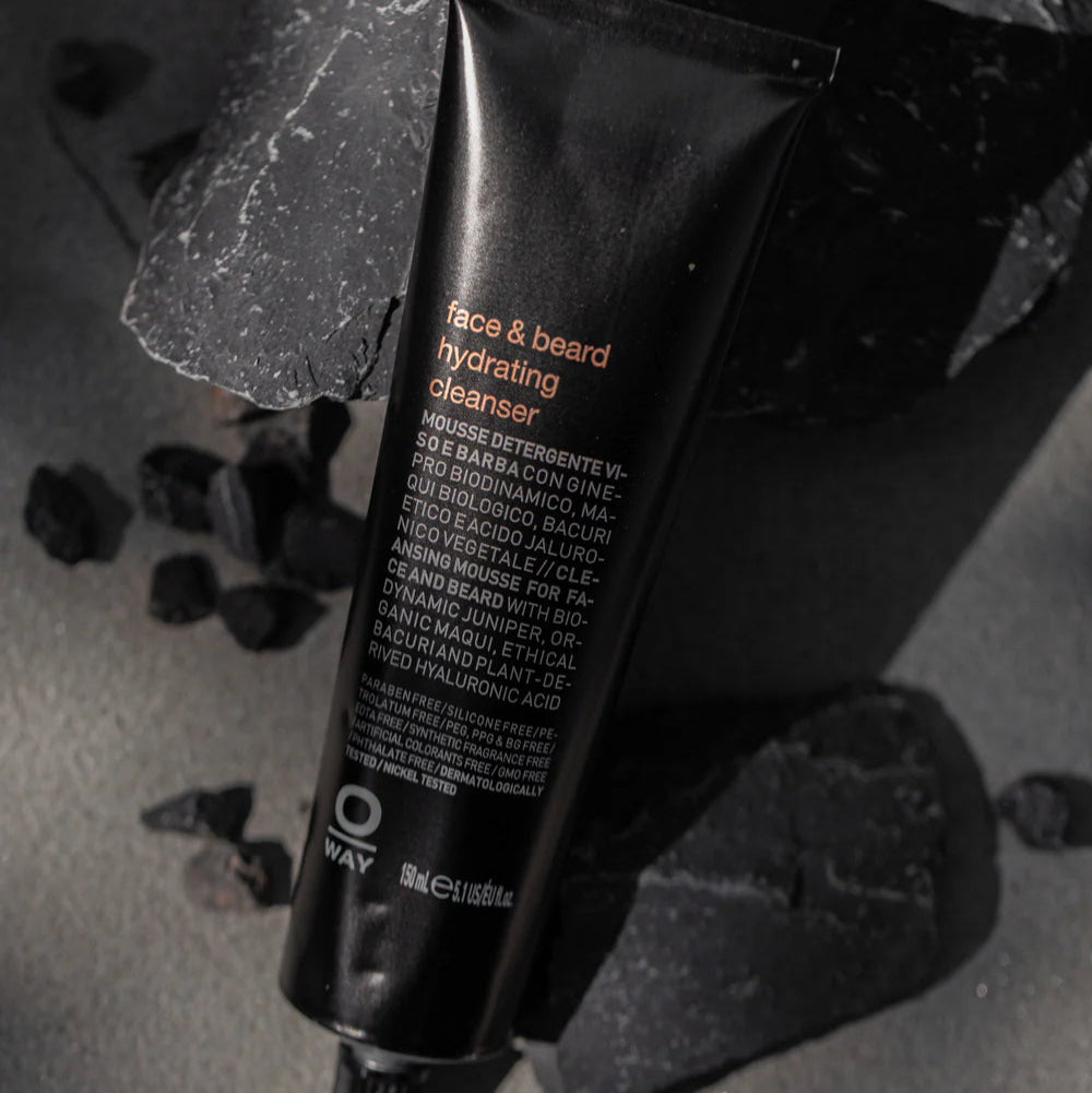 Black tube of face and beard hydrating cleanser on a dark surface