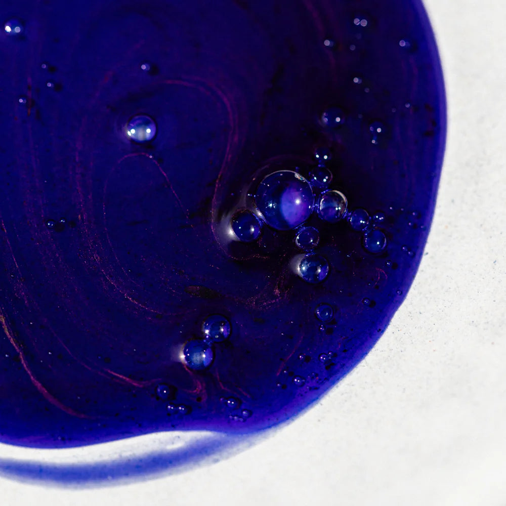 Close-up of Oway Silver Steel hair bath liquid with bubbles on a white background