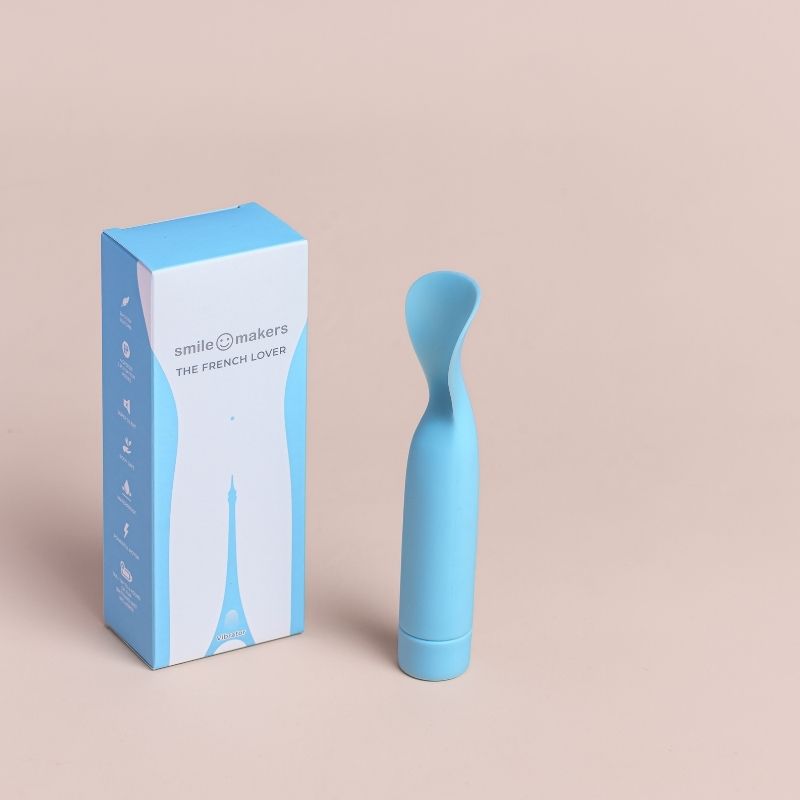 The French Lover Vibrator brought to you by Smile Makers. Picture shows the vibrator standing next to the box.